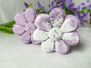 Purple flower-shaped bath bombs with glitter on a light background by Vermont Lavender handmade