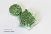 Green glittery bath bomb with snowflake design on a white background by Vermont Lavender